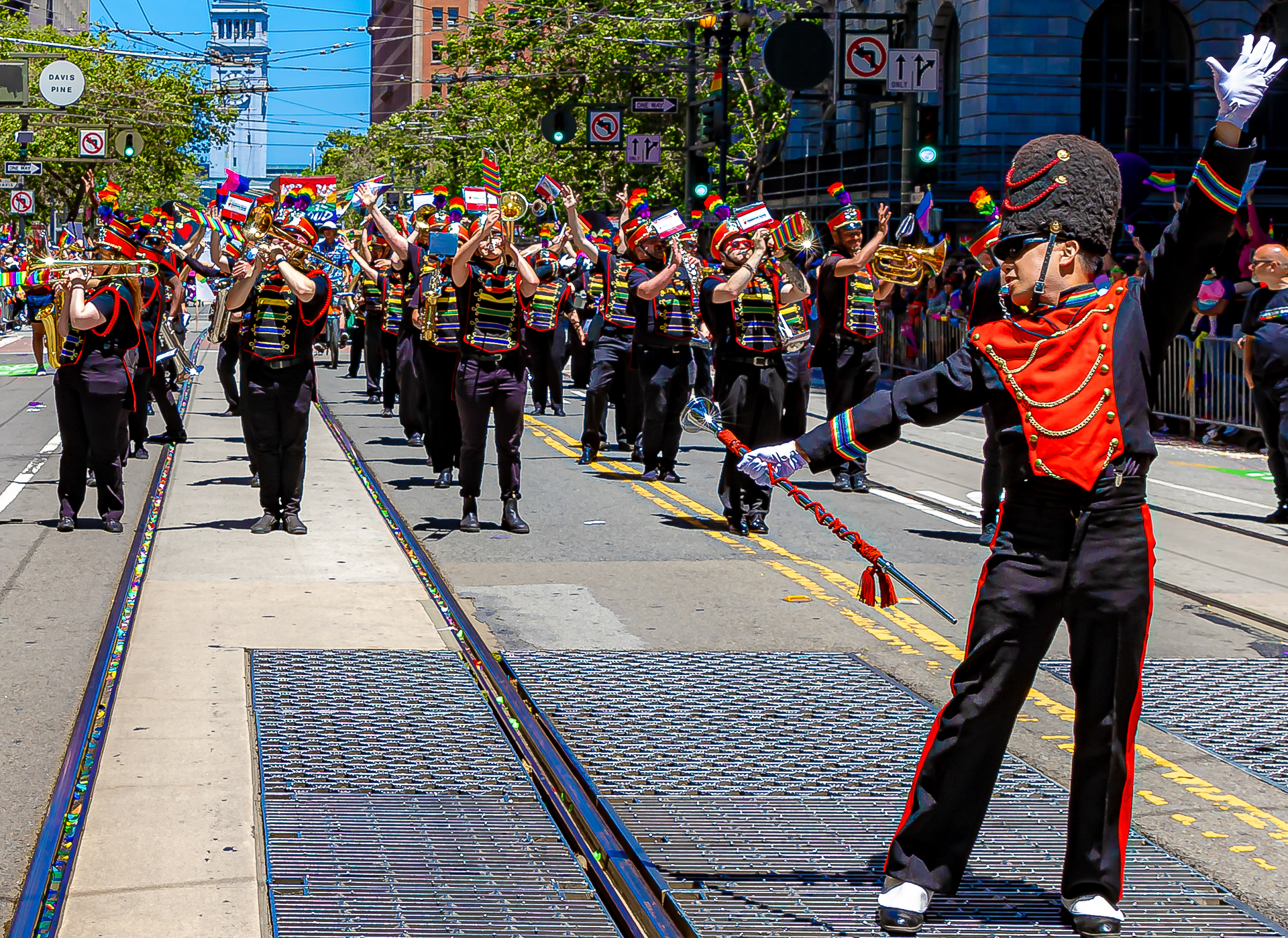 Band member playing saxophone with rainbow plume shining in the sun
